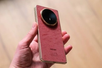 Honor Magic V6 in red held by hand