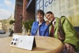 Motorola Razr Fold with smiling couple at cafe