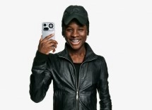 Young man holds Nothing Phone (4a) Pro with metal frame.