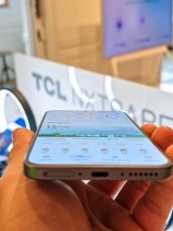 Close-up of TCL NxtPaper smartphone with AMOLED display.