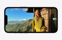 iPhone 17e display shows woman, mountains, sunny sky.