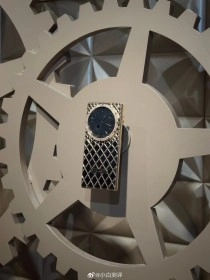 Gold Dreame luxury phone with round display.