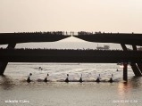Phu Quoc island bridge with people and boats.