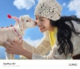 girl and goat outdoors.