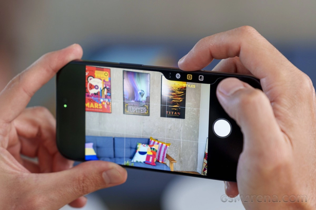 iPhone camera app showing posters on wall.