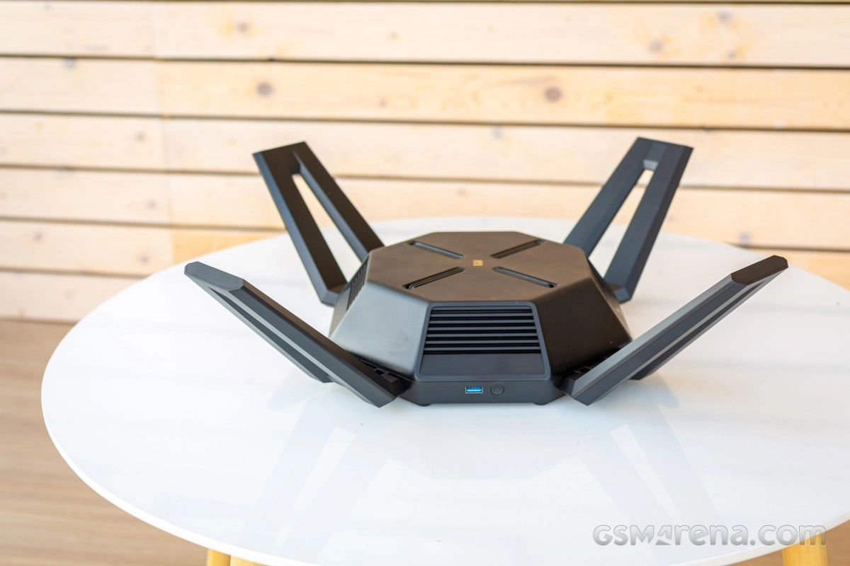 Black Wi-Fi router with multiple antennas on table.
