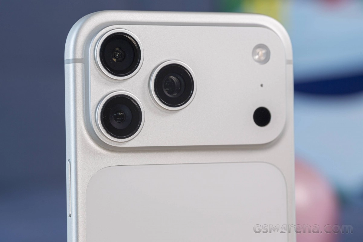 Triple camera array on silver iPhone rear.