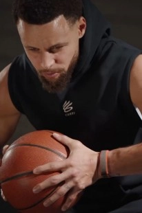 Stephen Curry wears fitness tracker, holds basketball