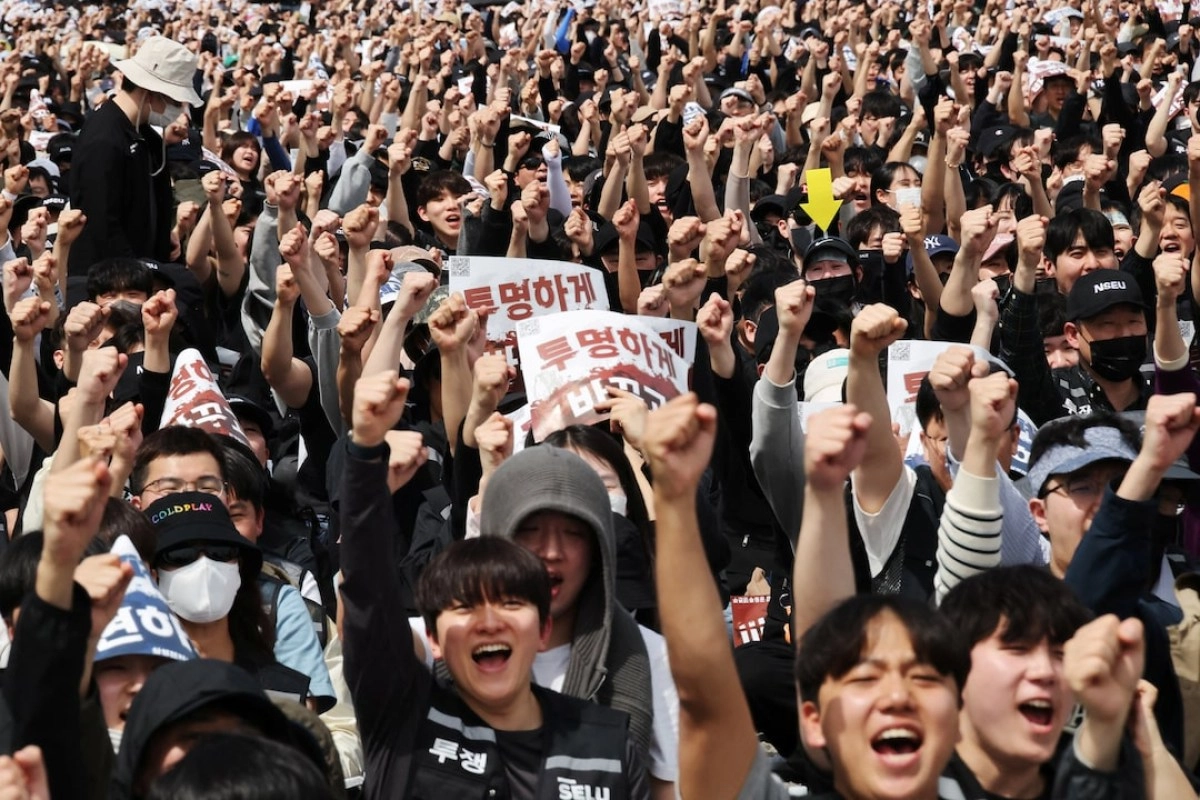 Samsung chip manufacturing labor protest with raised fists.
