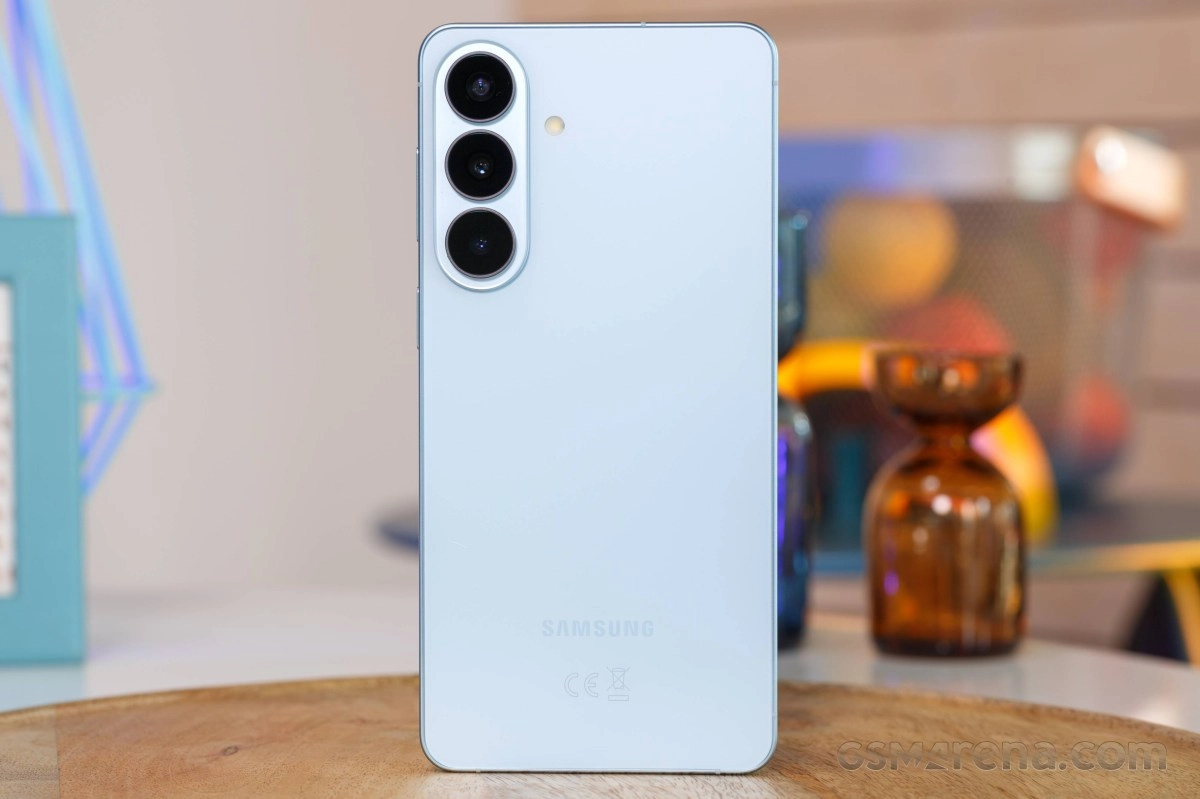 Rear view of white Samsung S27 with triple camera.