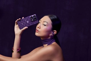 Woman holding new purple Motorola Signature phone.
