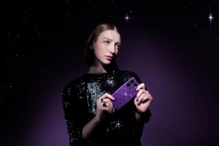 Woman holding new purple Motorola Signature phone.