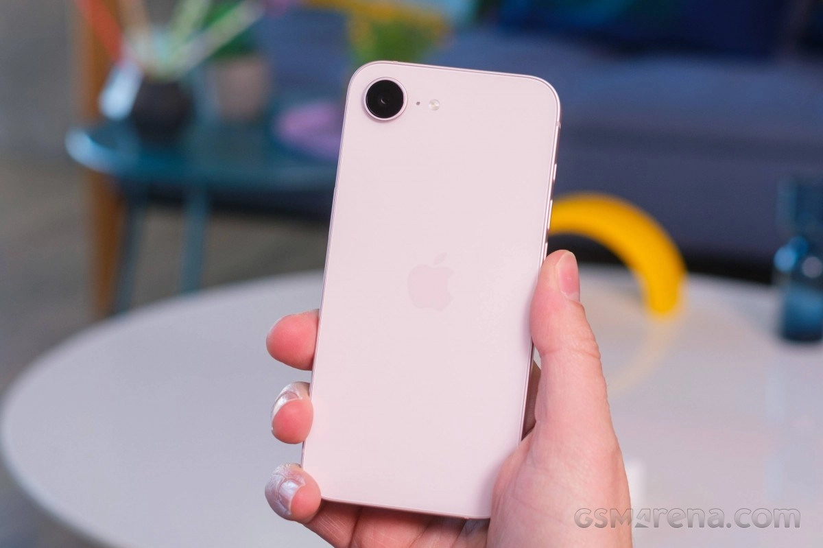 Pink iPhone 17 held in hand, Apple logo visible.