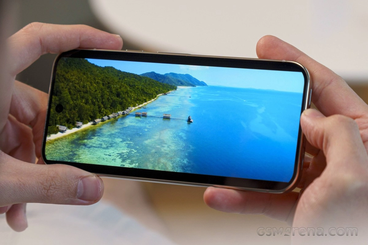 Pixel 11 Pro smartphone displays tropical island with huts.