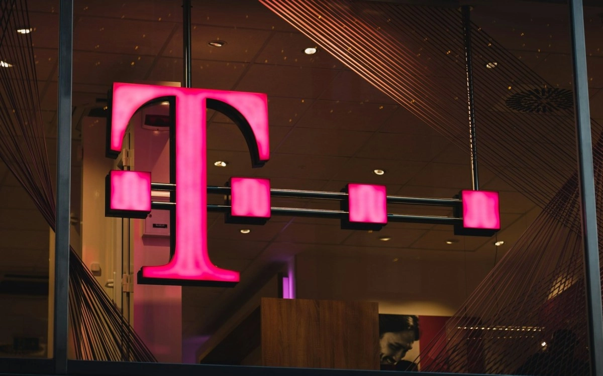 T-Mobile logo with four promotional devices.