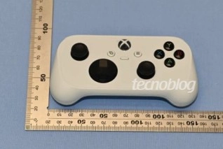 White Xbox controller next to ruler, product image.