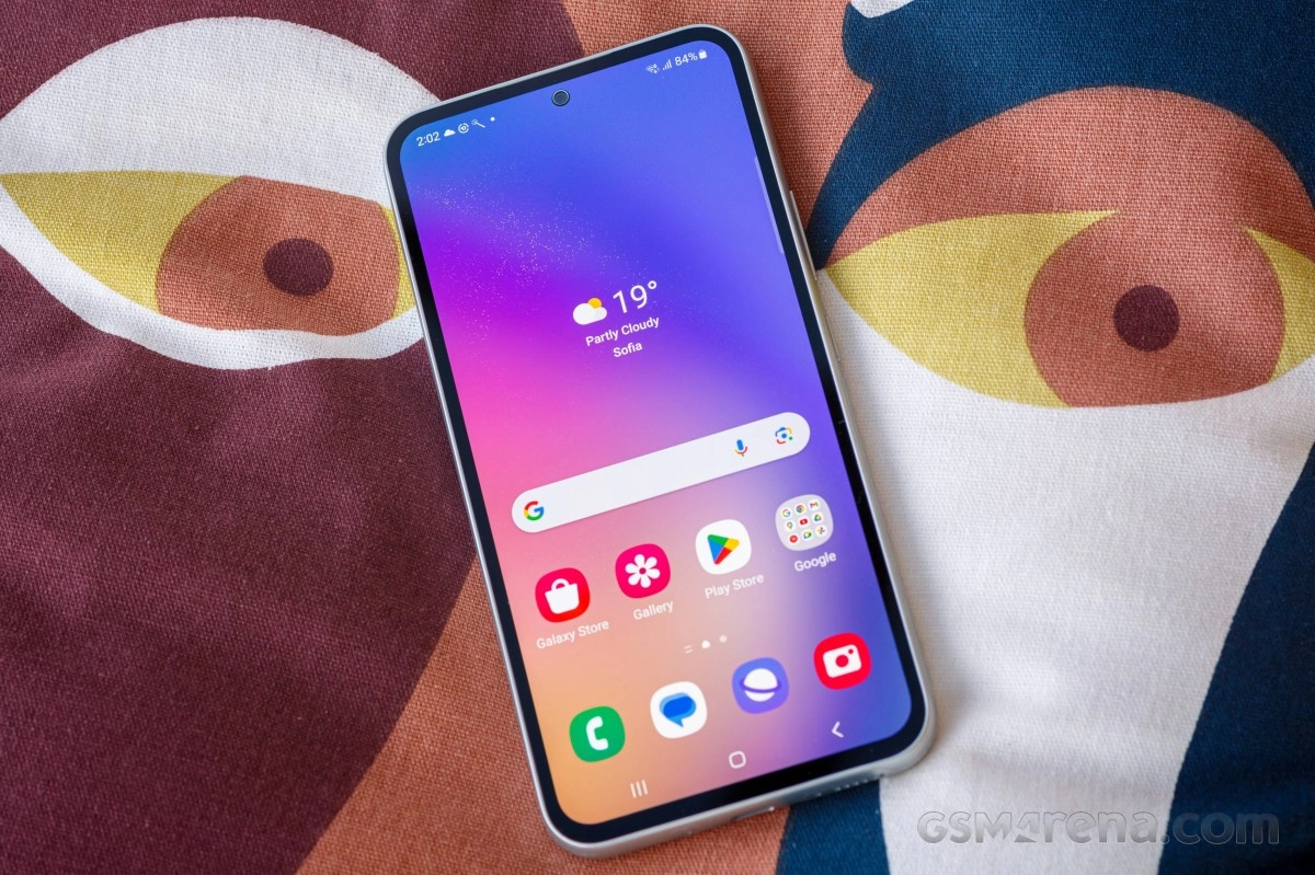 Samsung Galaxy A54 phone on patterned background.