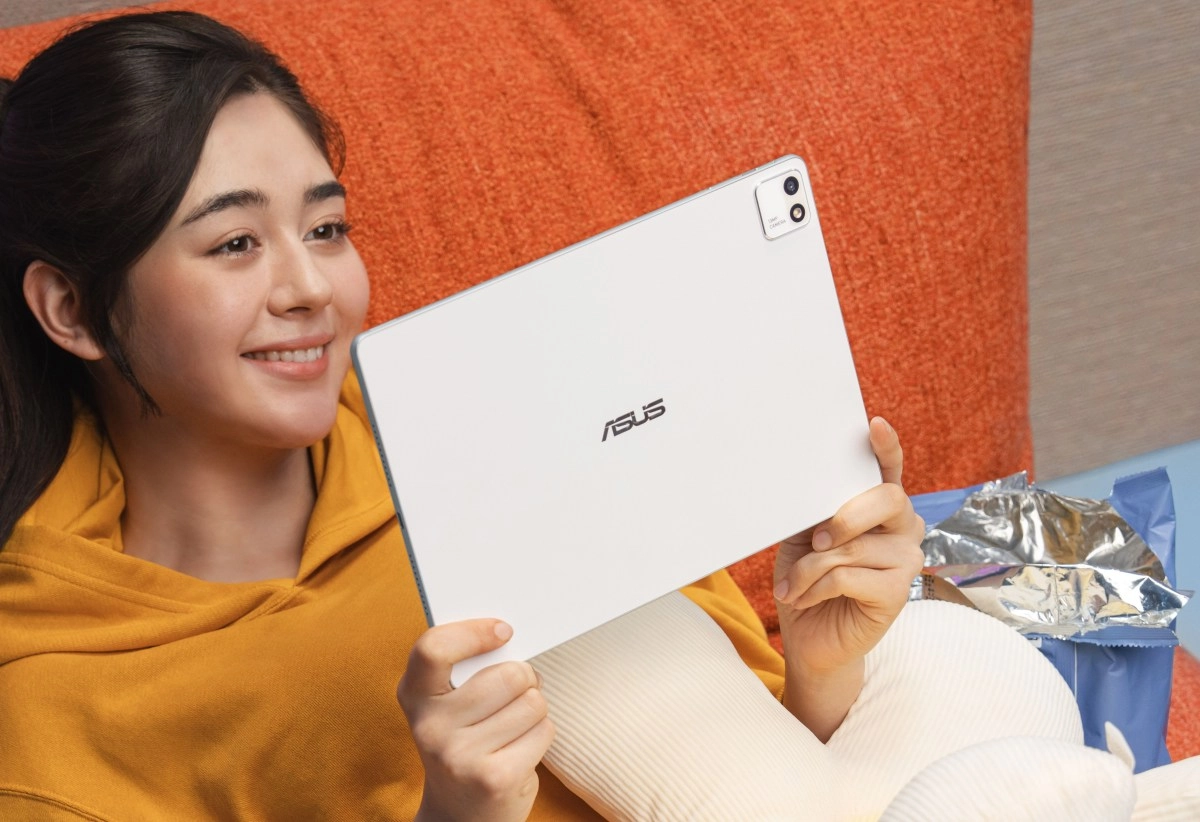 Asus 12.2-inch tablet held by smiling woman.