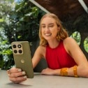 Woman holding green Motorola Edge (2026) phone.