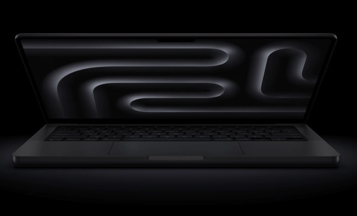 Dark grey MacBook with abstract wallpaper on screen.
