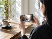 Sharp Aquos R11 held by person, showing telephoto photo.