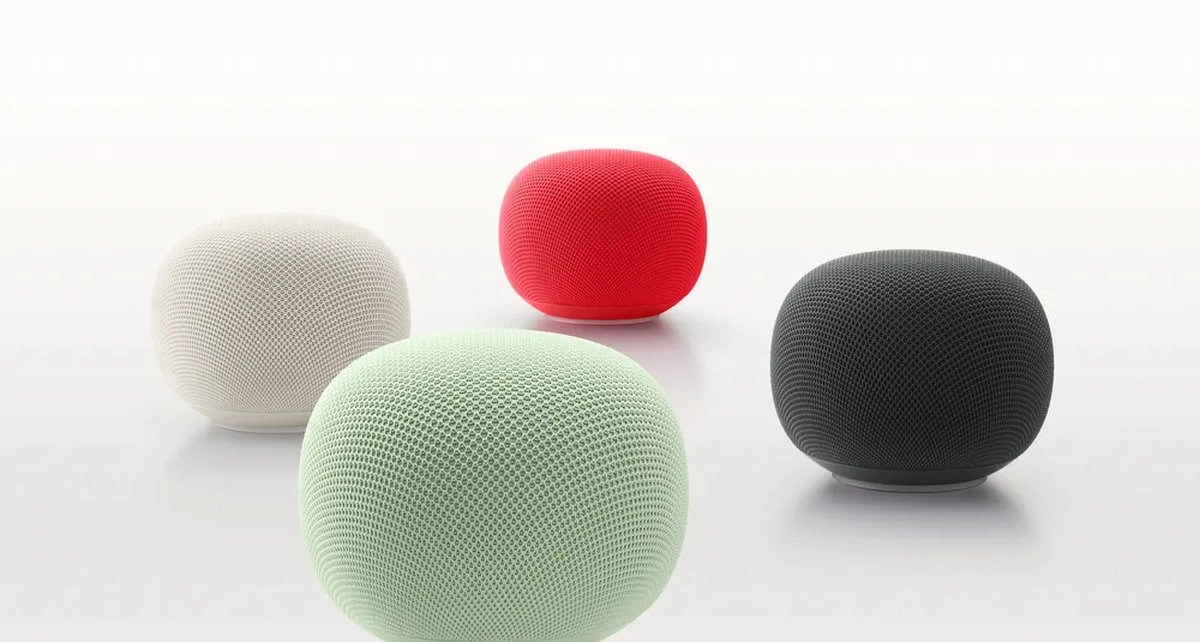 Four Google Home speakers in assorted colors.