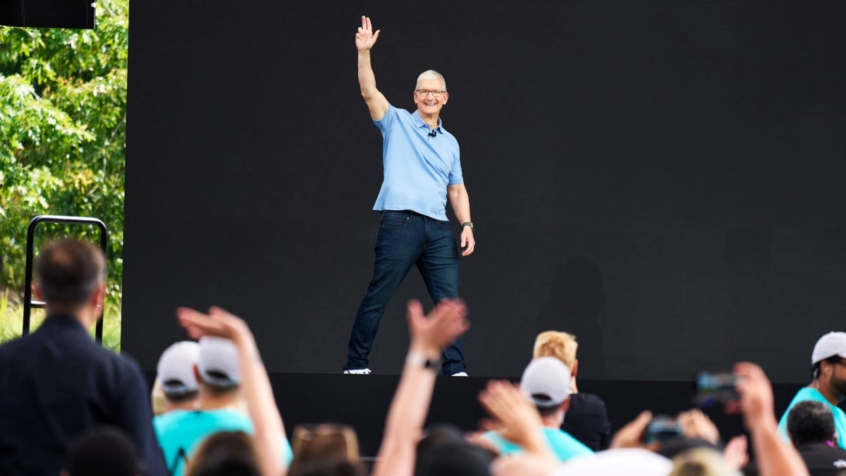 Apple CEO Tim Cook waves to audience.