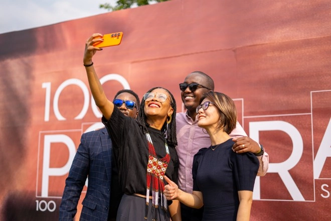 Four people take a selfie with a Tecno phone.