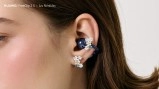 Huawei FreeClip 2 S earbuds in a woman's ear.