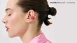 Red flower-shaped Huawei FreeClip 2 S earbud on woman.