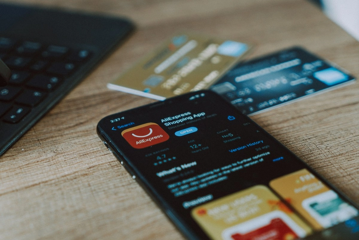 AliExpress app on phone with credit cards