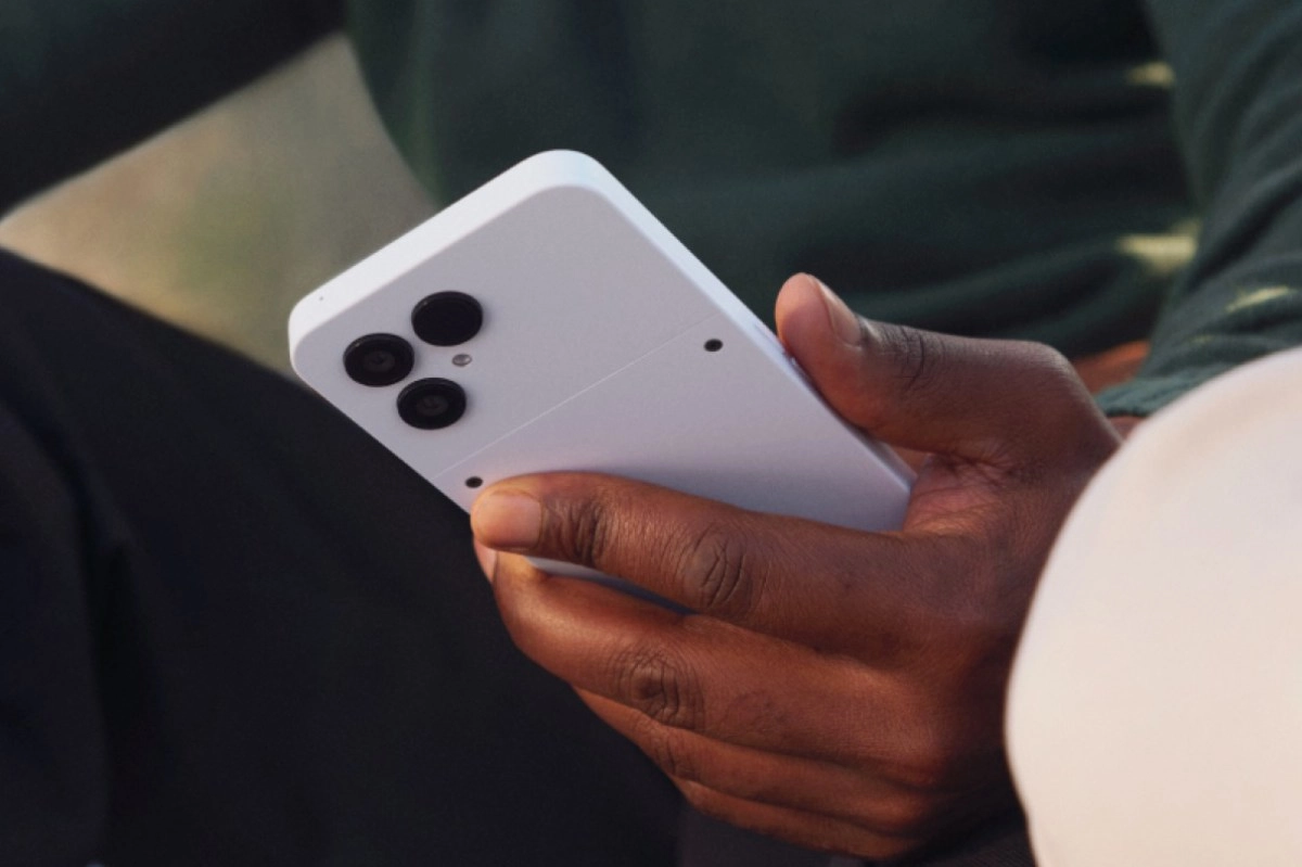 White Fairphone 6+ in hand with triple camera.