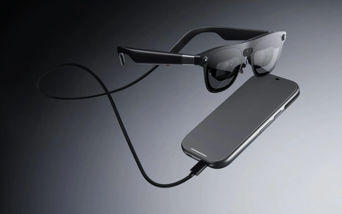 Smart glasses connected to smartphone via cable.