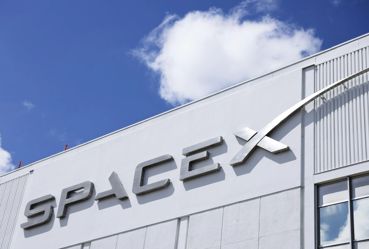 SpaceX logo on building against blue sky