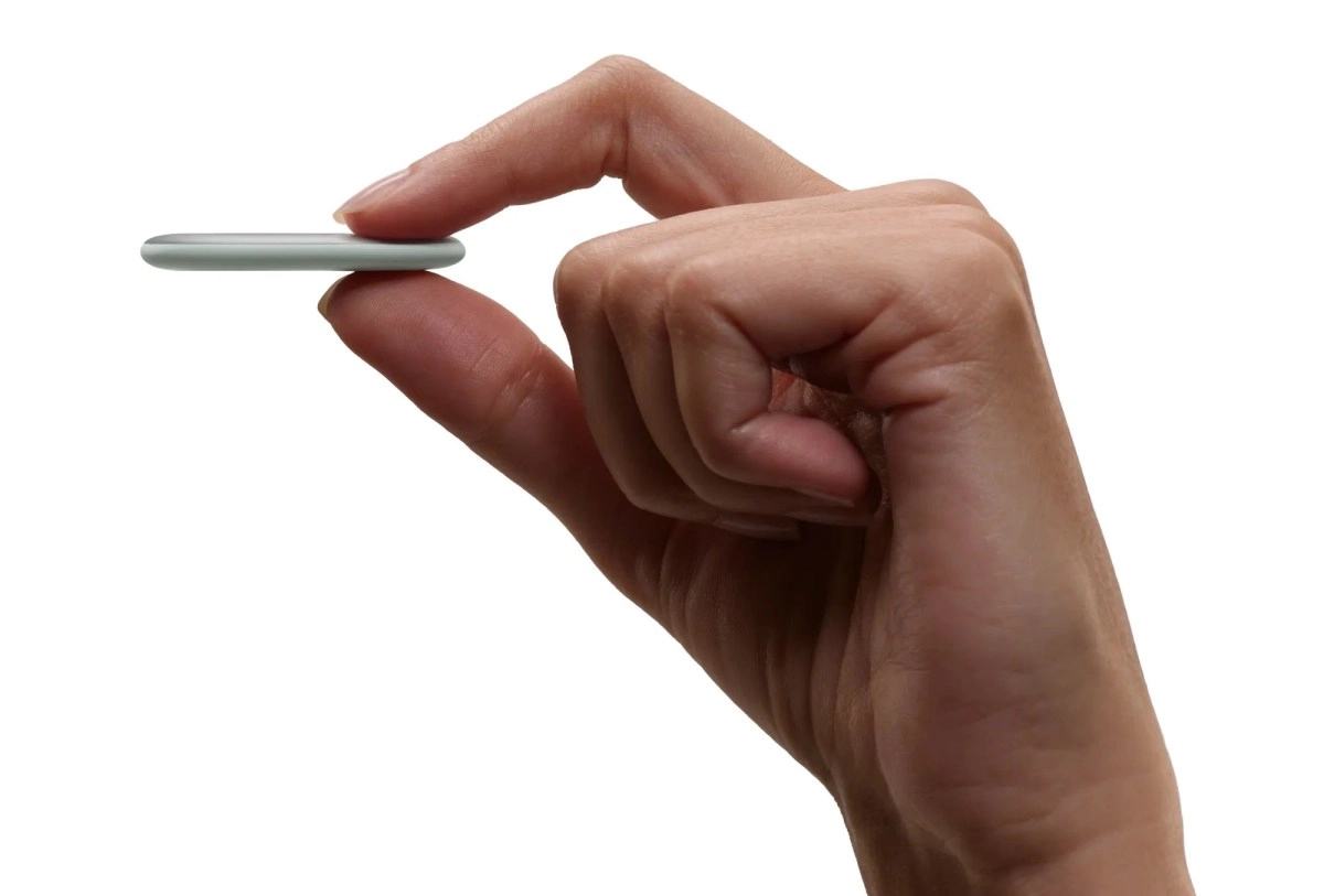 Google Pixel Tag held between fingers, UWB.