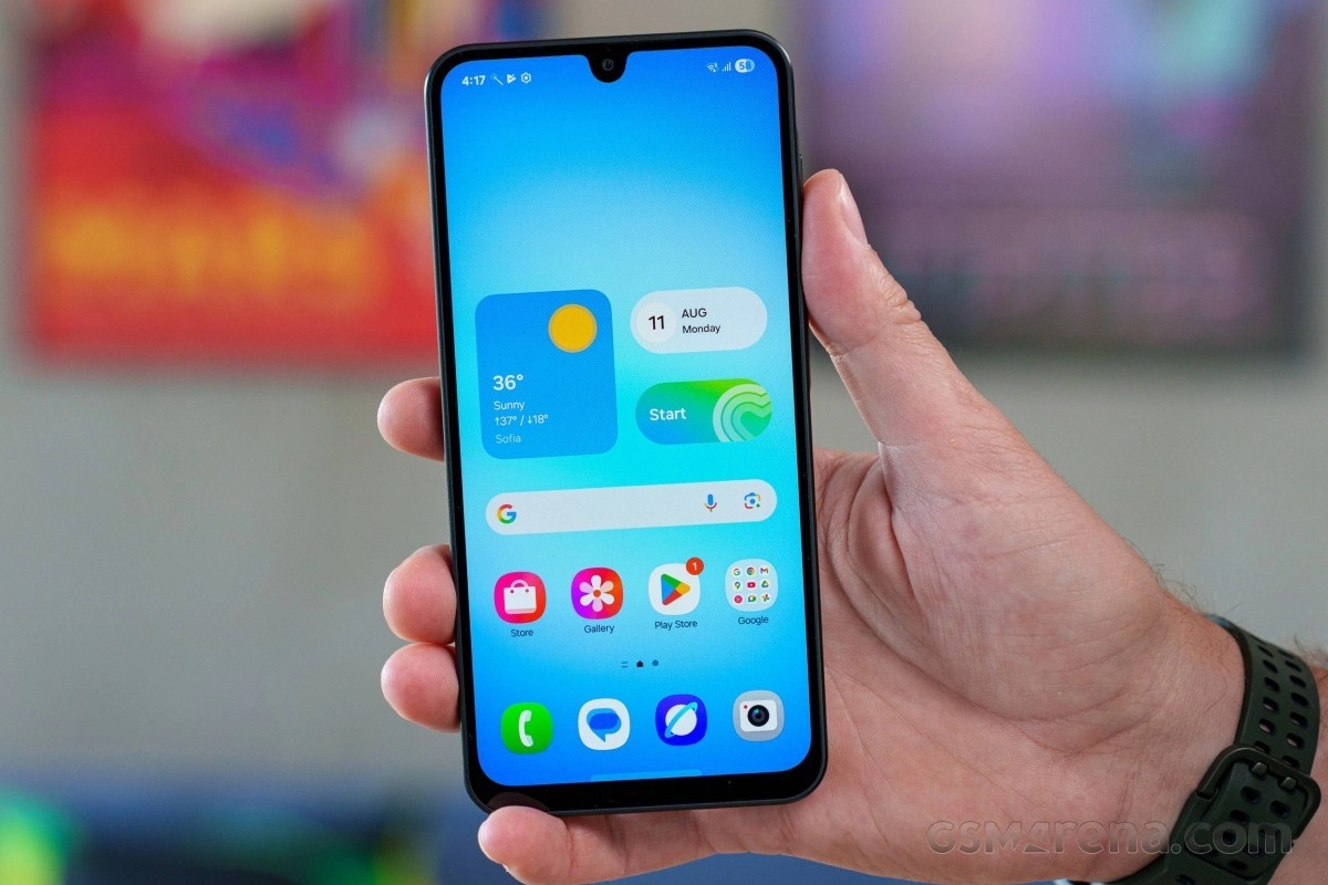 Smartphone held in hand with budget device icons visible.