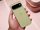 Olive green Google Pixel phone in hand.