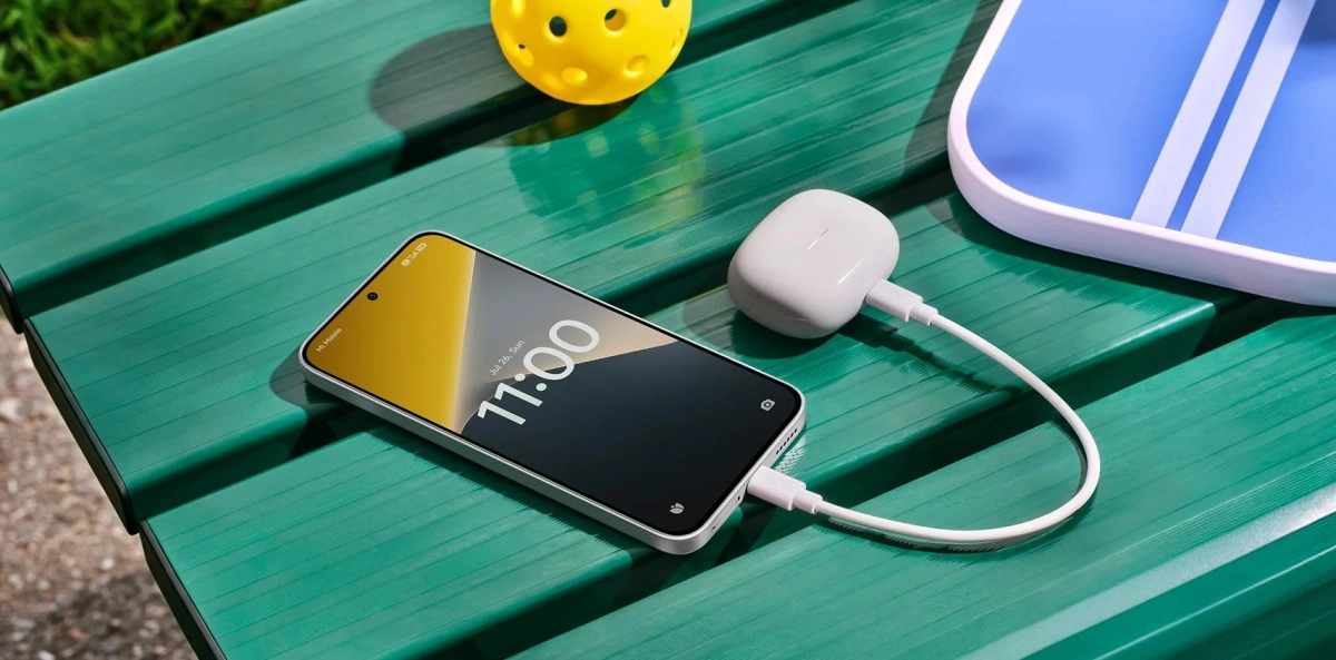 Poco X8 phone charging on green bench