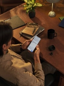 Person using TCL P80 Ultra NxtPaper OLED phone.