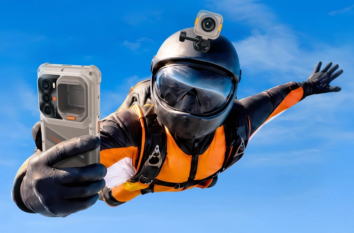 Skydiver holds RugOne Xsnap 7 Pro, detachable camera.