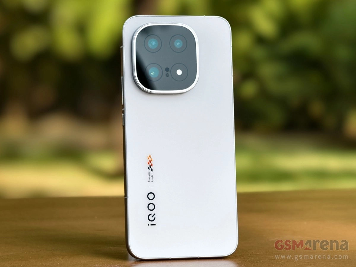 White iQOO phone with quad camera module.
