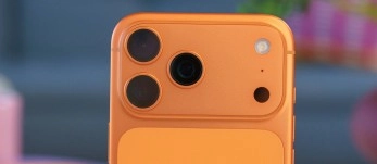 Orange phone camera setup with three lenses.