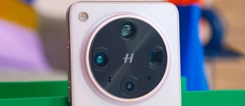 Phone camera array with 'H' logo.
