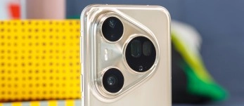 Close-up of a gold smartphone triple camera system.