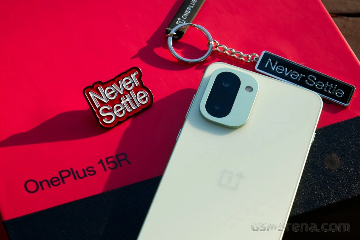 OnePlus 15R smartphone with Never Settle accessories.