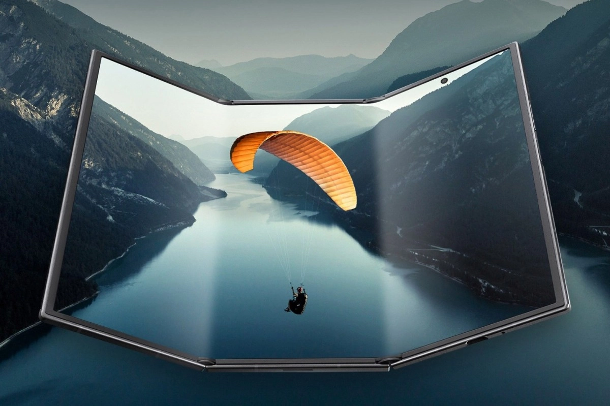 Foldable phone displays paraglider over serene lake.