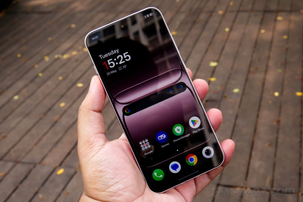 OnePlus 15T smartphone held in hand, front view.