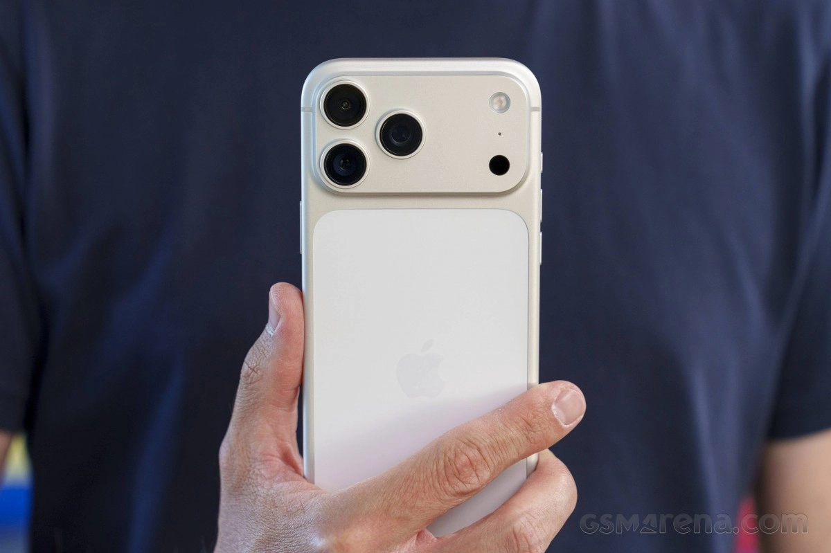 Close-up of white iPhone with triple camera.