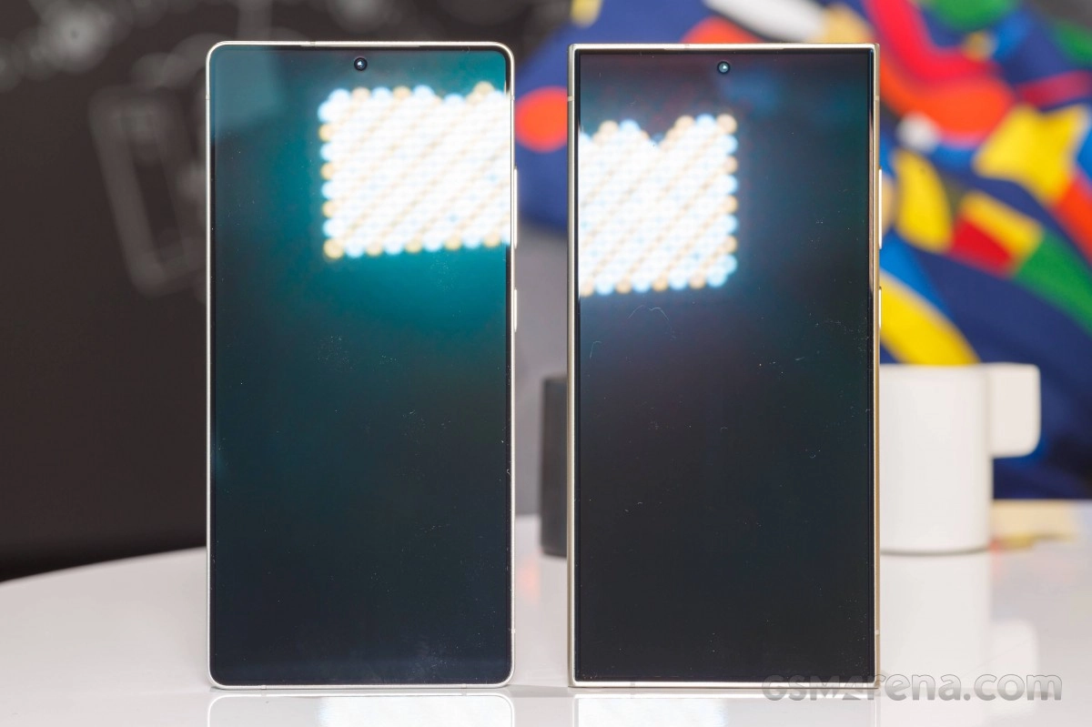 Two phones with reflective screens side-by-side.