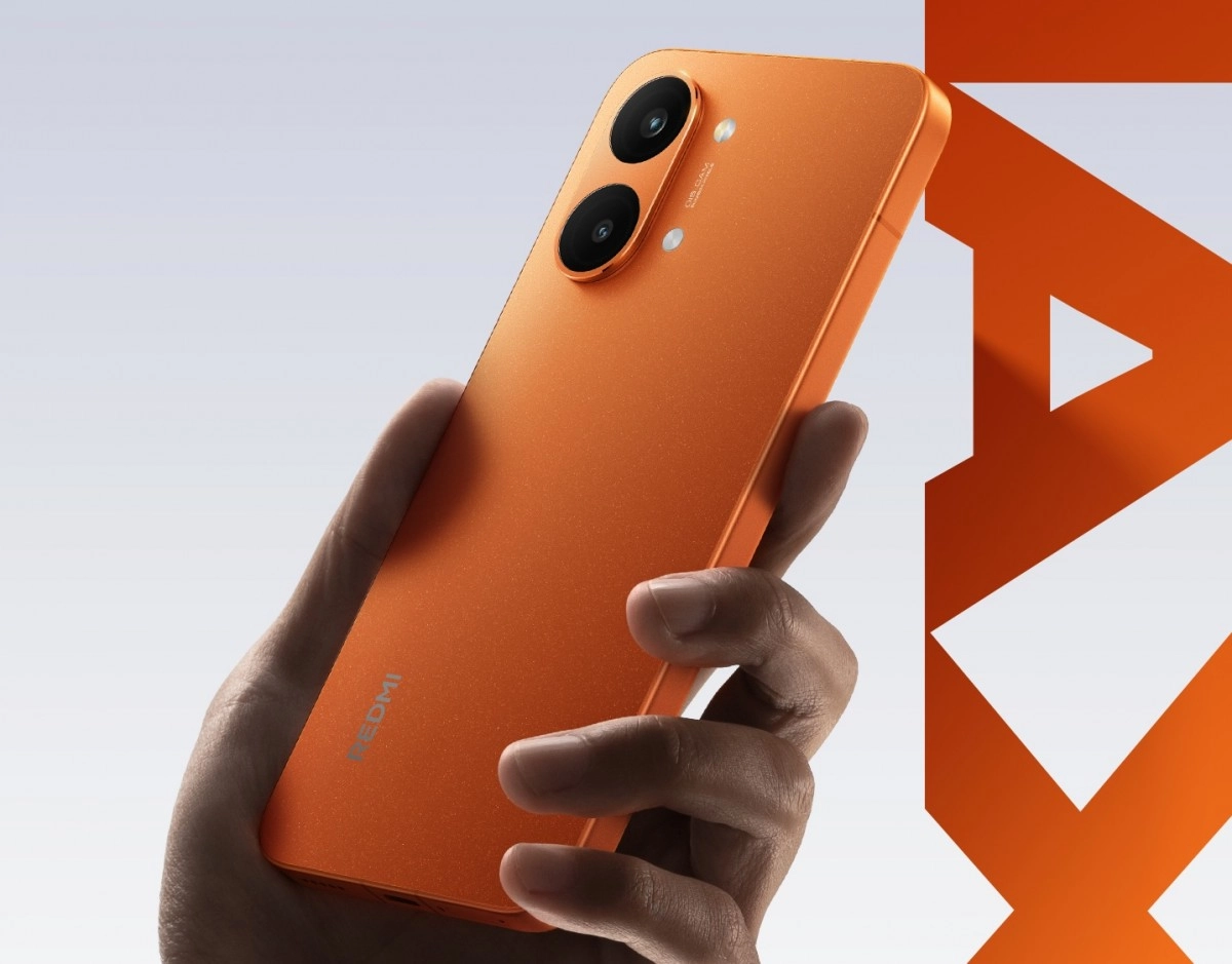 Redmi Turbo 5 orange phone held in hand